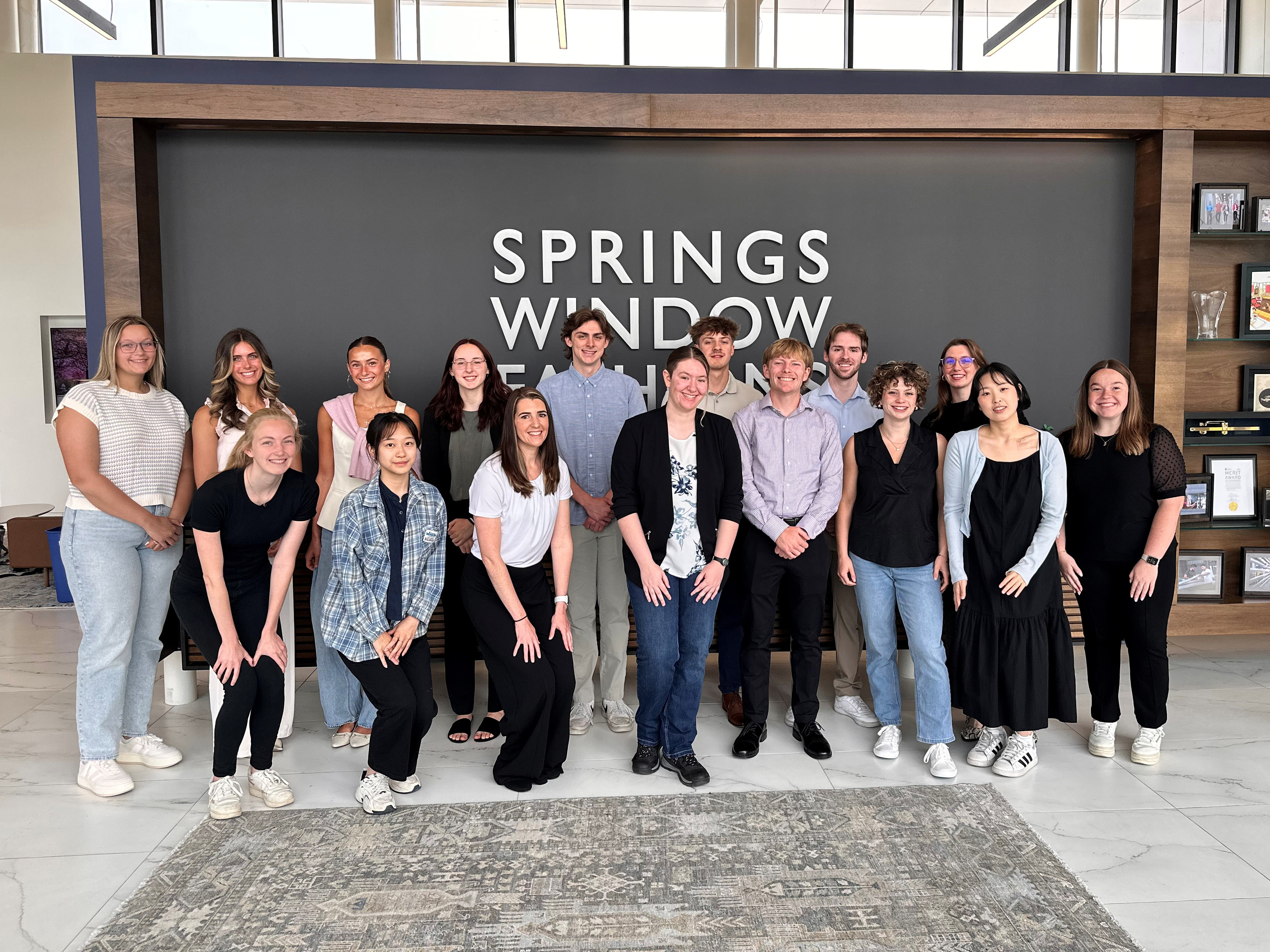 Interns photographed together in springs window fashions lobby